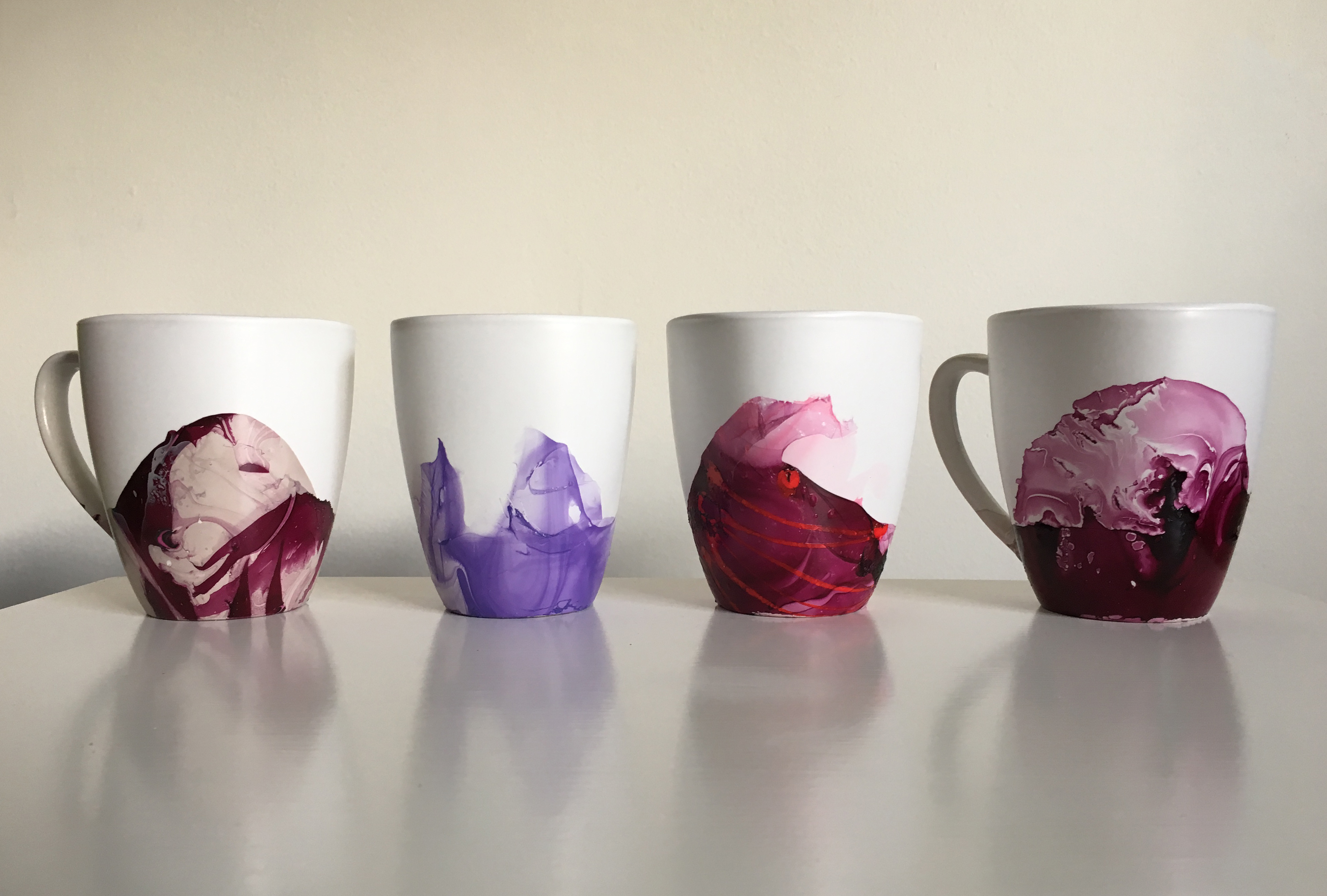 image of four coffee mugs with unique, marbled-style designs