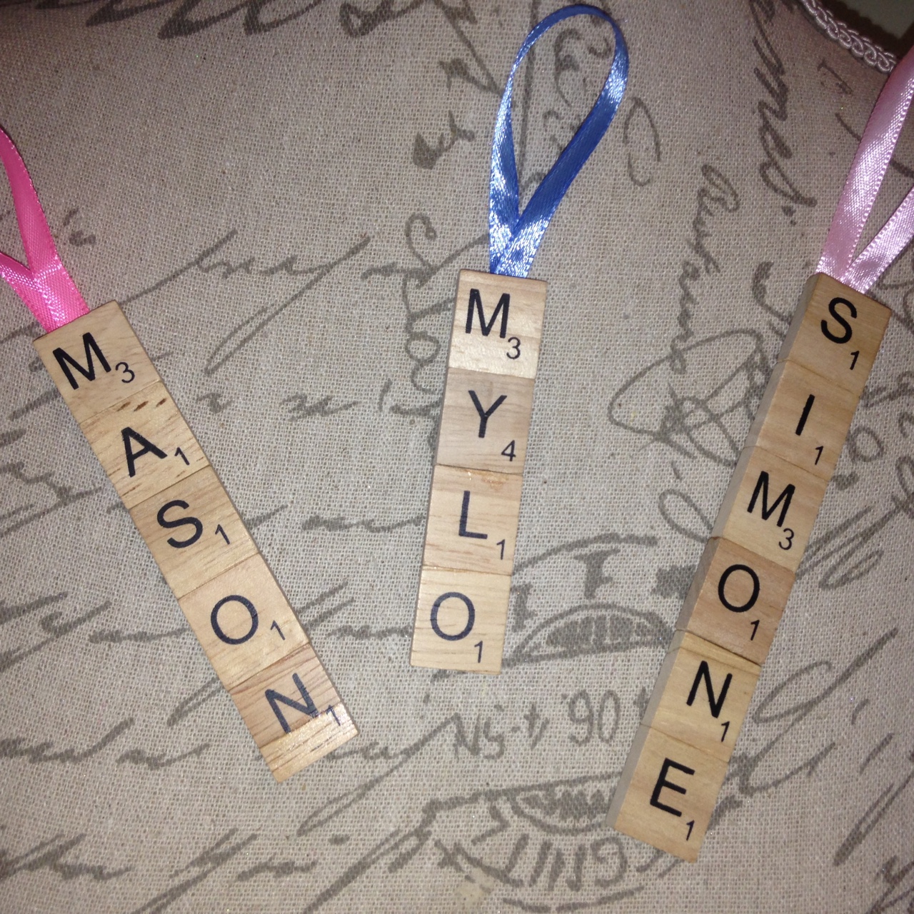 scrabble tiles spell names and are attached to keyrings