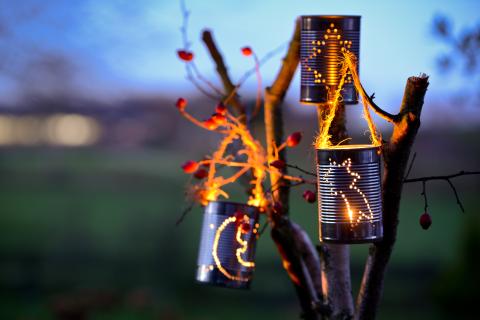 Tin can lanterns hanging in tree